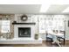 Cozy living room with a white brick fireplace, decorative mantle, and adjacent breakfast nook at 1288 Gambel Oaks Dr, Elizabeth, CO 80107
