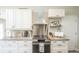 Updated kitchen featuring stainless steel range hood and white cabinets at 1288 Gambel Oaks Dr, Elizabeth, CO 80107