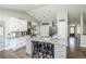 Modern kitchen with an island, stainless steel appliances, white cabinets, and an open layout to the hallway at 1288 Gambel Oaks Dr, Elizabeth, CO 80107