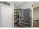 Pantry shelves and baskets next to a modern stainless steel refrigerator in the kitchen at 1288 Gambel Oaks Dr, Elizabeth, CO 80107