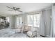Comfortable living room with ceiling fan, accent chairs, and large windows at 1288 Gambel Oaks Dr, Elizabeth, CO 80107