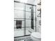 Modern glass shower with marble tile and black accents, showcasing contemporary design and functionality at 1288 Gambel Oaks Dr, Elizabeth, CO 80107