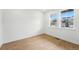 Well-lit bedroom with hardwood floors and two windows offering neighborhood views at 1667 Fox Trotter Pt, Castle Rock, CO 80104