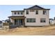 Rear exterior of two-story home showing large windows, backyard porch and professional exterior finishes at 1667 Fox Trotter Pt, Castle Rock, CO 80104