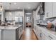 Well-equipped kitchen features white cabinets, modern backsplash, and stainless steel appliances at 1667 Fox Trotter Pt, Castle Rock, CO 80104