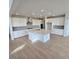 Bright kitchen featuring white cabinets, a large island, and stainless steel appliances at 1667 Fox Trotter Pt, Castle Rock, CO 80104