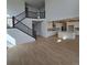 Spacious living area with hardwood floors that connects the staircase and kitchen at 1667 Fox Trotter Pt, Castle Rock, CO 80104