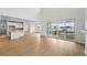 Bright living area with wood floors, large sliding doors, a view of the kitchen, and an open floor plan at 1667 Fox Trotter Pt, Castle Rock, CO 80104