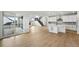 Open-concept living room showcases hardwood floors, natural light, a fireplace, and a modern staircase at 1667 Fox Trotter Pt, Castle Rock, CO 80104