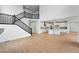 Bright and airy living space with high ceilings, wood floors, and a staircase leading to the second floor at 1667 Fox Trotter Pt, Castle Rock, CO 80104