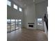 Open-concept living room with high ceilings, a fireplace, and access to a deck at 1667 Fox Trotter Pt, Castle Rock, CO 80104