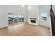 Spacious living room with a fireplace, wood floors, large sliding doors to a balcony, and lots of natural light at 1667 Fox Trotter Pt, Castle Rock, CO 80104