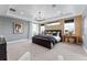 Bright main bedroom with wood accent wall, and ample natural light from several windows at 1667 Fox Trotter Pt, Castle Rock, CO 80104