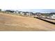 New construction community with white fences, dirt yard ready for landscaping, and mountain views at 1667 Fox Trotter Pt, Castle Rock, CO 80104