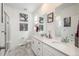 Modern bathroom with dual sinks, white cabinetry, and a glass-enclosed shower at 688 N Bersshine Ct, Watkins, CO 80137