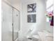 Bright bathroom featuring a glass shower, artistic wall decor, and a decorative floral arrangement near the window at 688 N Bersshine Ct, Watkins, CO 80137