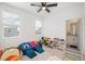 Playroom featuring large windows, a modern ceiling fan, and colorful toys creating an inviting play space at 688 N Bersshine Ct, Watkins, CO 80137
