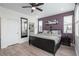 Stylish bedroom featuring a dark accent wall, modern furniture, and ample natural light at 688 N Bersshine Ct, Watkins, CO 80137