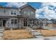 Attractive townhouse showcasing a welcoming porch, stone detailing, and well-maintained landscaping at 688 N Bersshine Ct, Watkins, CO 80137