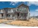 Stylish townhome features a covered front porch, stone accents, and a neat front yard at 688 N Bersshine Ct, Watkins, CO 80137