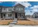 Charming townhouse with stone accents, inviting porch, and landscaped front yard on a sunny day at 688 N Bersshine Ct, Watkins, CO 80137