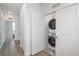 Laundry room features a stacked washer and dryer hidden behind doors at 688 N Bersshine Ct, Watkins, CO 80137