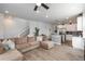 Open-concept living space showcasing a modern kitchen and comfortable lounge area at 688 N Bersshine Ct, Watkins, CO 80137