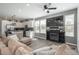 Bright living room with modern fireplace, stylish furniture, and open concept to the kitchen at 688 N Bersshine Ct, Watkins, CO 80137