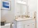 Bathroom featuring a vanity with a sink, a large mirror, and neutral tiling at 1395 Abilene Dr, Broomfield, CO 80020