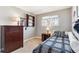 Inviting bedroom features a bed, natural light from a window, dresser, and shelf at 1395 Abilene Dr, Broomfield, CO 80020