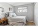 Simple bedroom features a comfortable bed, natural light from a window, and closet at 1395 Abilene Dr, Broomfield, CO 80020