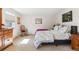 Bedroom with a wooden rocking chair, neutral carpet, a queen bed and a painting on the wall at 1395 Abilene Dr, Broomfield, CO 80020