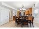 This dining area with tan tile floor is next to the kitchen with wooden cabinets and granite countertops at 1395 Abilene Dr, Broomfield, CO 80020