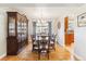 Elegant dining room with a large china cabinet, wooden table, and chandelier lighting at 1395 Abilene Dr, Broomfield, CO 80020