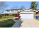 Lovely two-story home featuring brick accents, a red door and an attached two car garage at 1395 Abilene Dr, Broomfield, CO 80020
