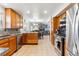 Spacious kitchen featuring wooden cabinets, granite countertops and stainless steel appliances at 1395 Abilene Dr, Broomfield, CO 80020