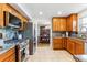 Kitchen featuring wooden cabinets, stainless steel appliances and granite countertops at 1395 Abilene Dr, Broomfield, CO 80020