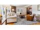Bright living room featuring hardwood floors, a patterned rug, and comfortable seating at 1395 Abilene Dr, Broomfield, CO 80020