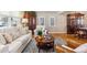 Bright living room with hardwood floors, comfortable seating, and a round wooden coffee table at 1395 Abilene Dr, Broomfield, CO 80020