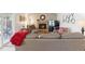 Cozy living room boasts a red brick fireplace, comfortable seating, and neutral carpet at 1395 Abilene Dr, Broomfield, CO 80020