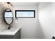Modern bathroom with an oval mirror, decorative tile backsplash, and a sleek vanity sink at 2170 Vine Ave, Boulder, CO 80304