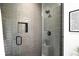 Modern shower with sleek tile, matte black fixtures, built-in niche, and clear glass door at 2170 Vine Ave, Boulder, CO 80304