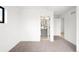 Spacious bedroom with neutral carpet, ensuite bathroom with tile flooring and gray vanity, and multiple doors at 2170 Vine Ave, Boulder, CO 80304