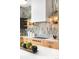 Well-lit kitchen with sleek appliances, modern cabinetry, and decorative open shelving at 2170 Vine Ave, Boulder, CO 80304