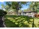 Expansive backyard featuring a well-maintained lawn and mature trees offering shade and privacy at 7036 S Apache St, Littleton, CO 80120