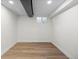 Unfinished basement space featuring laminate flooring and a window for natural light at 7036 S Apache St, Littleton, CO 80120