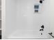 Clean bathroom featuring white tiled walls, and modern fixtures at 7036 S Apache St, Littleton, CO 80120