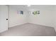 An additional bedroom with neutral carpet, white walls, and two windows providing natural light at 7036 S Apache St, Littleton, CO 80120