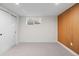 Cozy bedroom featuring carpeted floors, white walls, natural wood paneling accent, and a closet with sliding doors at 7036 S Apache St, Littleton, CO 80120