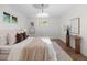 Bright bedroom with hardwood floors, natural colors, a decorative rug, modern lighting, and large windows at 7036 S Apache St, Littleton, CO 80120